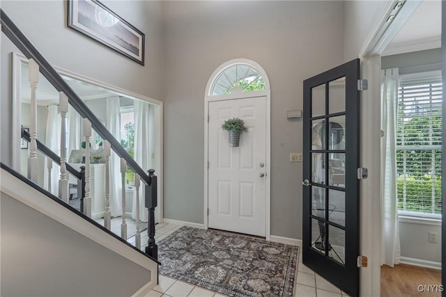9607 Dunderry, Lysander, NY 13027 - entrance foyer with plenty of natural light, stairway, and light tile patterned flooring