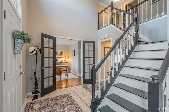 9607 Dunderry, Lysander, NY 13027 - tiled entryway featuring french doors, crown molding, a towering ceiling, and stairway