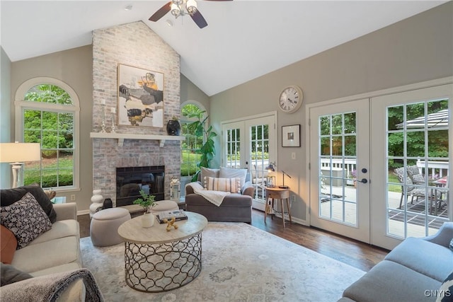 9607 Dunderry, Lysander, NY 13027 - living area with french doors, high vaulted ceiling, wood finished floors, ceiling fan, and a fireplace