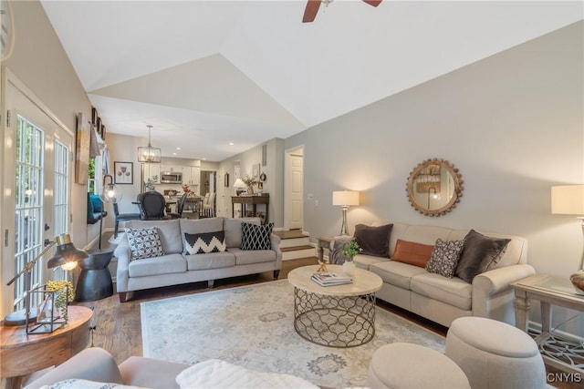 9607 Dunderry, Lysander, NY 13027 - living area featuring wood finished floors, a ceiling fan, high vaulted ceiling, and a chandelier