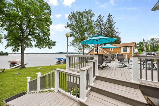 4969 Walnut Cove Dr, Canandaigua Town, NY 14424 - wooden deck with outdoor dining space, a water view, and a yard