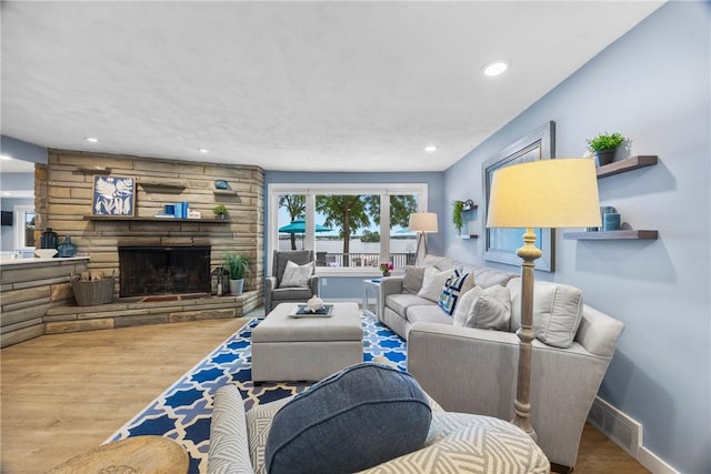4969 Walnut Cove Dr, Canandaigua Town, NY 14424 - living room featuring wood finished floors, recessed lighting, and a stone fireplace