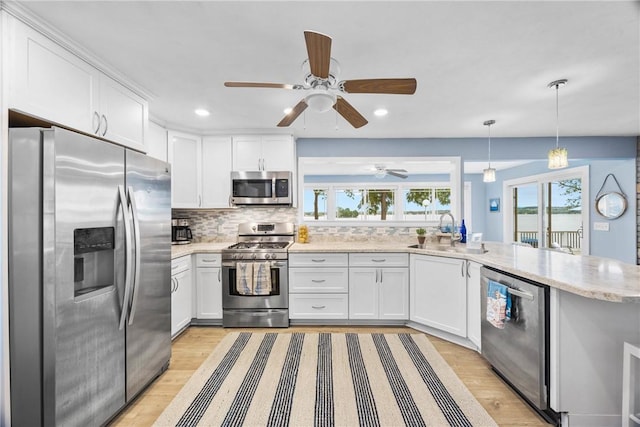 4969 Walnut Cove Dr, Canandaigua Town, NY 14424 - kitchen featuring stainless steel appliances, light wood finished floors, a peninsula, white cabinetry, and recessed lighting