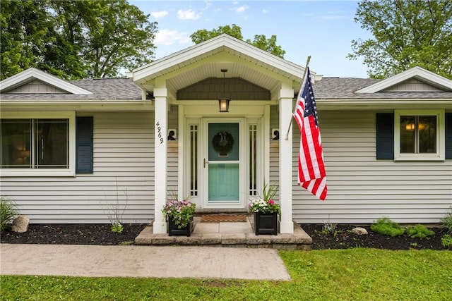 4969 Walnut Cove Dr, Canandaigua Town, NY 14424 - property entrance featuring roof with shingles and a yard