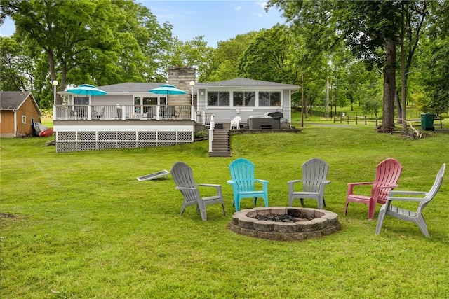 4969 Walnut Cove Dr, Canandaigua Town, NY 14424 - rear view of house featuring a fire pit, a wooden deck, stairs, and a lawn