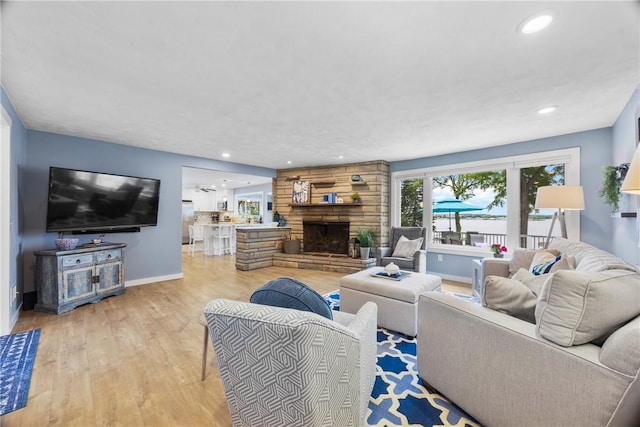4969 Walnut Cove Dr, Canandaigua Town, NY 14424 - living room featuring light wood finished floors, recessed lighting, and a fireplace