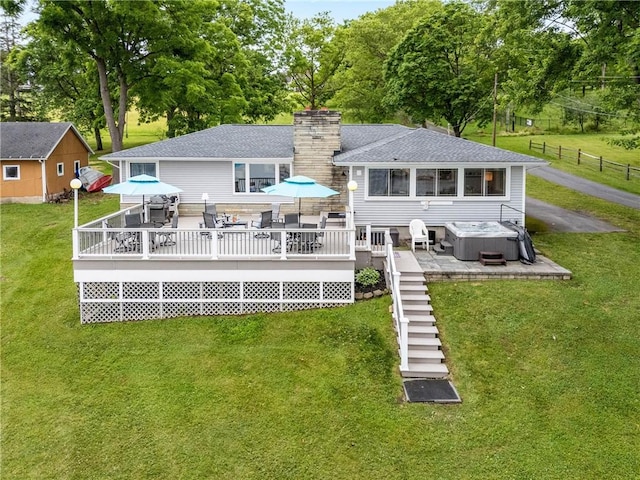 4969 Walnut Cove Dr, Canandaigua Town, NY 14424 - rear view of property with a hot tub, a deck, a chimney, a shingled roof, and view of wooded area