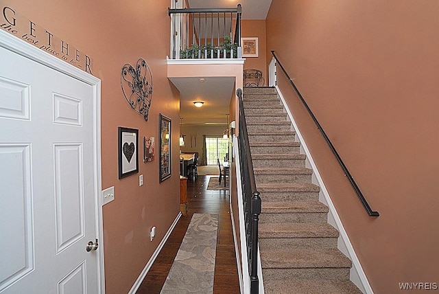 114 Slate Bottom Dr, Lancaster, NY 14043 - stairway featuring wood finished floors and a high ceiling