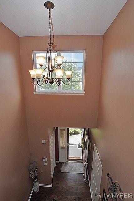 114 Slate Bottom Dr, Lancaster, NY 14043 - foyer with plenty of natural light, a chandelier, and dark wood-type flooring