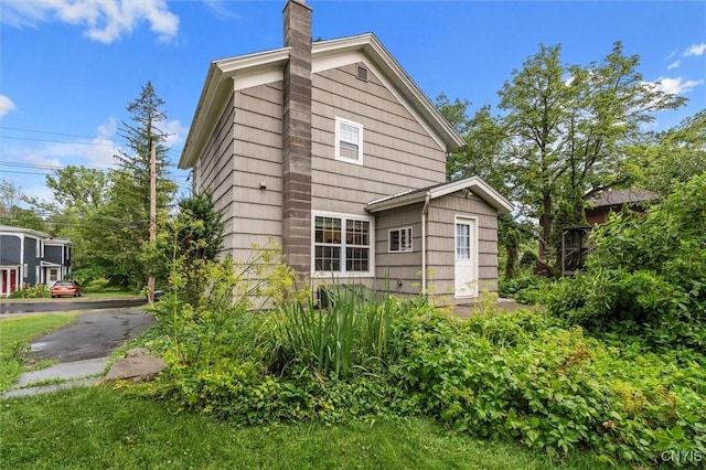 17 Burr St, Cazenovia, NY 13035 - rear view of property featuring a chimney