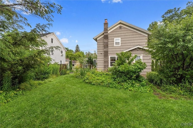 17 Burr St, Cazenovia, NY 13035 - view of side of home with a chimney and a yard
