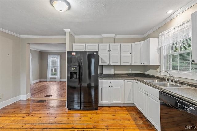 17 Burr St, Cazenovia, NY 13035 - kitchen featuring black appliances, light wood-style flooring, white cabinetry, ornamental molding, and dark countertops