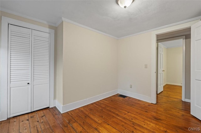 17 Burr St, Cazenovia, NY 13035 - unfurnished bedroom with a closet, wood-type flooring, and crown molding