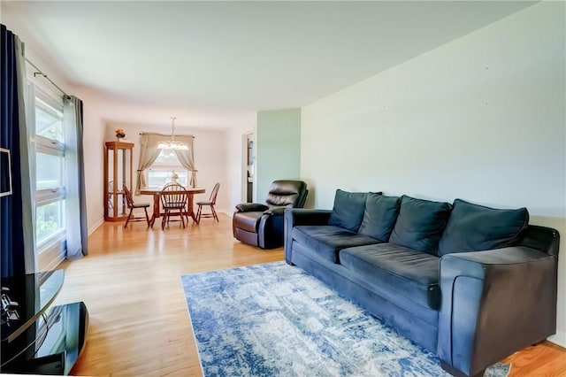 28 Berna Ln, Chili, NY 14624 - living area with light wood finished floors and a chandelier