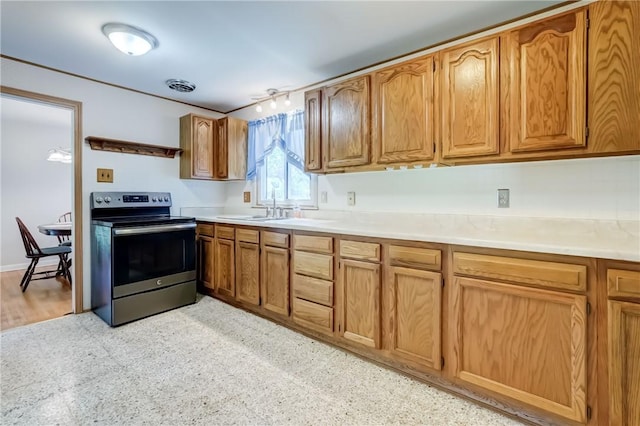 28 Berna Ln, Chili, NY 14624 - kitchen featuring stainless steel range with electric stovetop, light countertops, and brown cabinetry