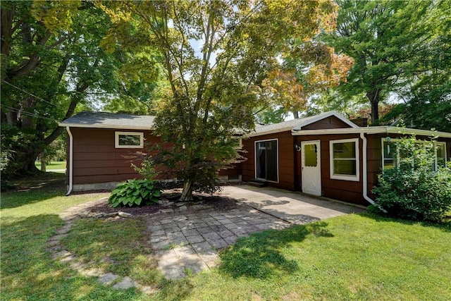28 Berna Ln, Chili, NY 14624 - back of property featuring a lawn and a patio area