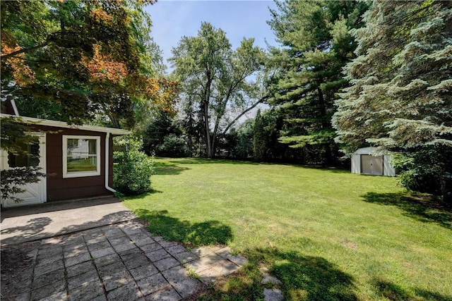 28 Berna Ln, Chili, NY 14624 - view of green lawn featuring a storage unit and a patio area