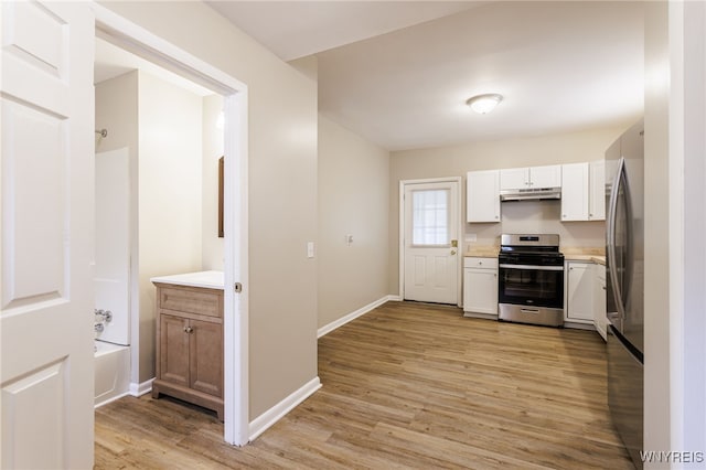 708 Garson Ave, Rochester, NY 14609 - kitchen featuring stainless steel appliances, under cabinet range hood, white cabinetry, and light wood-style floors