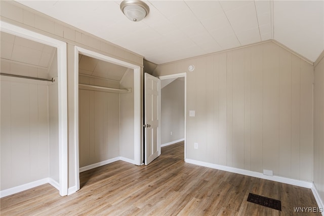 708 Garson Ave, Rochester, NY 14609 - unfurnished bedroom featuring light wood finished floors, a closet, and lofted ceiling
