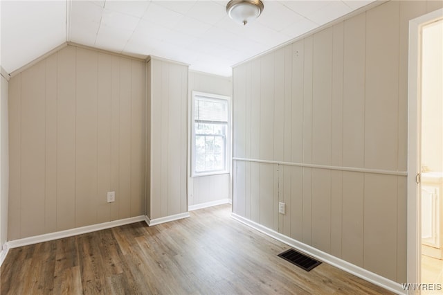 708 Garson Ave, Rochester, NY 14609 - empty room with wood finished floors and lofted ceiling