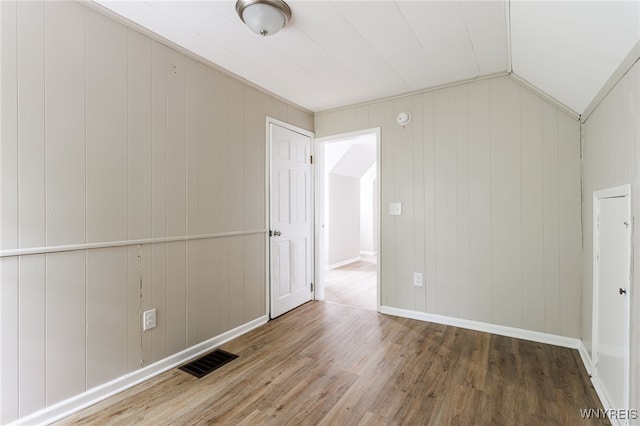 708 Garson Ave, Rochester, NY 14609 - unfurnished room with wood finished floors and lofted ceiling