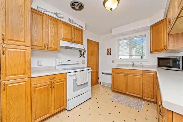 1732 Buffalo Rd, Gates, NY 14624 - kitchen with white electric range, stainless steel microwave, radiator heating unit, under cabinet range hood, and light floors