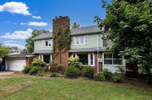 1065 W River Rd, Grand Island, NY 14072 - view of front of home featuring a chimney, an attached garage, a front lawn, and brick siding