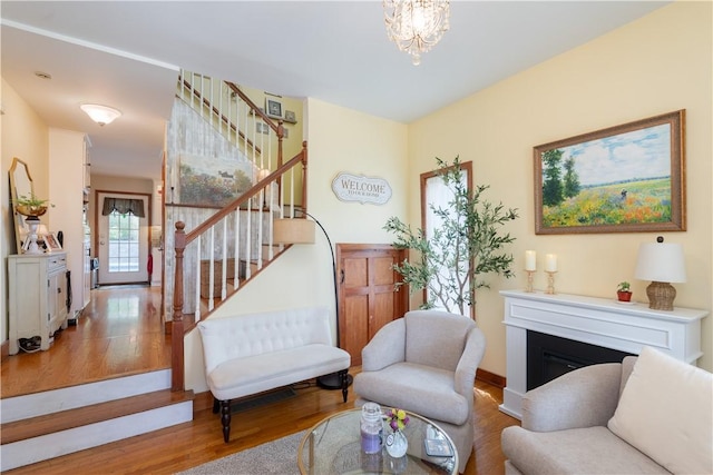 157 Dennis Ave, Hornell, NY 14843 - living area with stairway, wood finished floors, a fireplace, and a chandelier