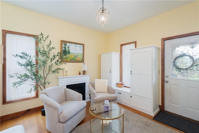 157 Dennis Ave, Hornell, NY 14843 - living area with a fireplace, wood finished floors, and a chandelier