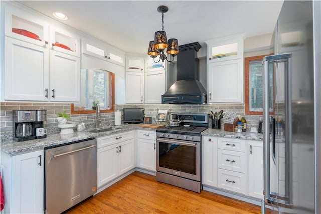157 Dennis Ave, Hornell, NY 14843 - kitchen with appliances with stainless steel finishes, wall chimney exhaust hood, a chandelier, white cabinets, and recessed lighting