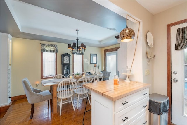 157 Dennis Ave, Hornell, NY 14843 - kitchen with wooden counters, a breakfast bar, a raised ceiling, white cabinetry, and a chandelier