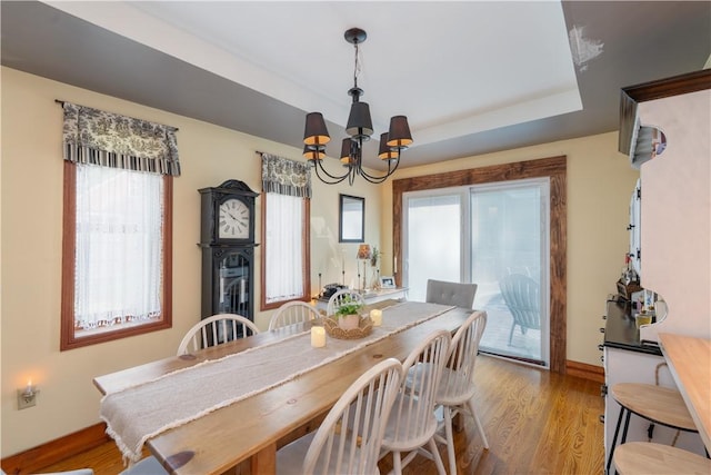 157 Dennis Ave, Hornell, NY 14843 - dining room featuring a chandelier, healthy amount of natural light, a raised ceiling, and wood finished floors