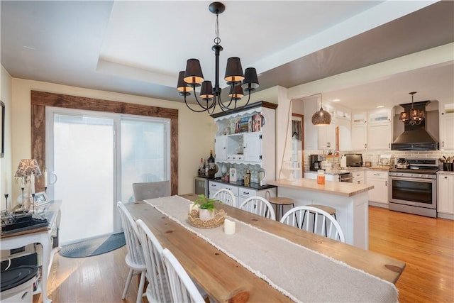 157 Dennis Ave, Hornell, NY 14843 - dining area with a chandelier, light wood finished floors, and a raised ceiling