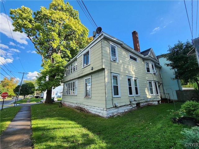 116 E Heman St, Dewitt, NY 13057 - view of side of home featuring a chimney and a lawn
