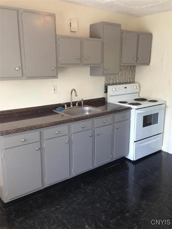 116 E Heman St, Dewitt, NY 13057 - kitchen featuring electric range, gray cabinetry, dark countertops, and a textured ceiling