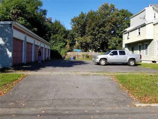 116 E Heman St, Dewitt, NY 13057 - view of asphalt driveway featuring community garages