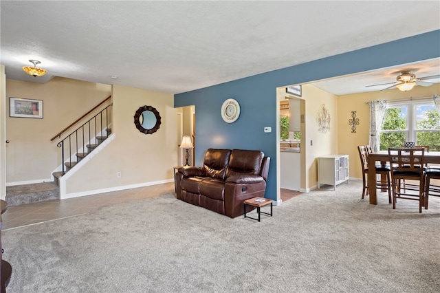 111 Farrell Road Ext, Henrietta, NY 14586 - carpeted living area featuring stairway, ceiling fan, and tile patterned flooring