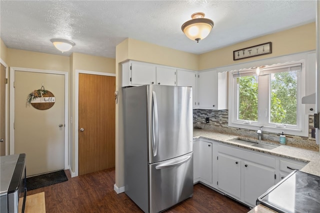 111 Farrell Road Ext, Henrietta, NY 14586 - kitchen with freestanding refrigerator, dark wood-style flooring, white cabinets, a textured ceiling, and backsplash