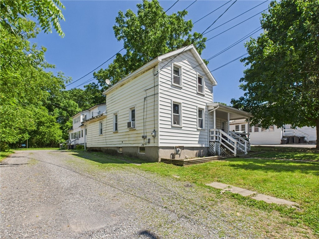 17 Perrine St, Auburn, NY 13021 - view of front facade with a front yard, cooling unit, and gravel driveway