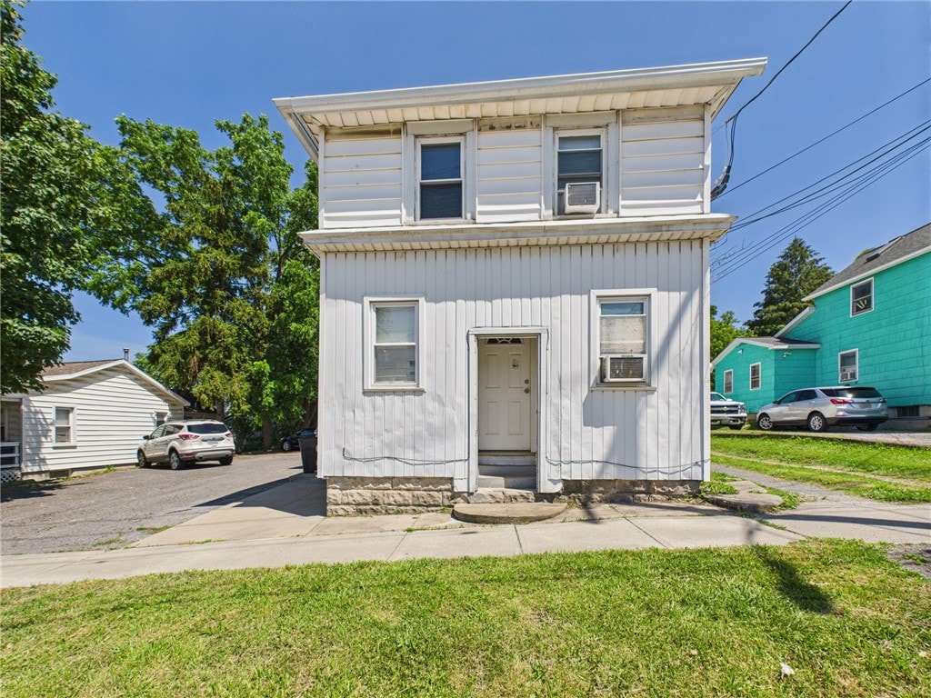 15 Perrine St, Auburn, NY 13021 - american foursquare style home featuring cooling unit, entry steps, and a front lawn