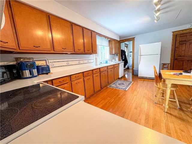 80 E Main St, Leroy, NY 14482 - kitchen featuring white appliances, brown cabinets, and light countertops