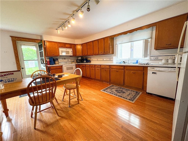 80 E Main St, Leroy, NY 14482 - kitchen featuring white appliances, track lighting, brown cabinetry, and light countertops