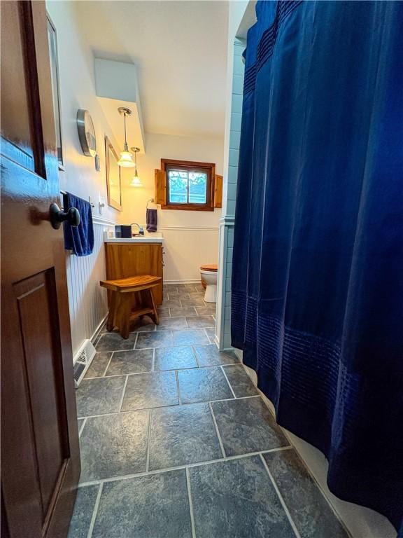 80 E Main St, Leroy, NY 14482 - bathroom featuring stone tile floors and vanity