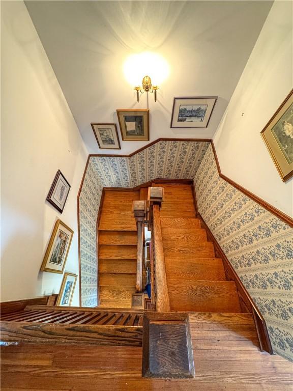 80 E Main St, Leroy, NY 14482 - staircase with hardwood / wood-style flooring and wallpapered walls