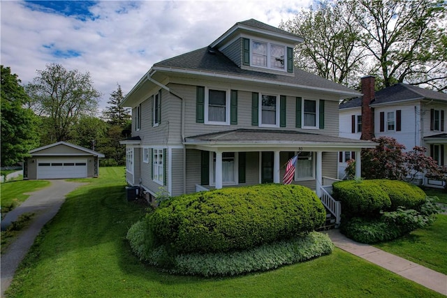 80 E Main St, Leroy, NY 14482 - traditional style home with an outbuilding, a detached garage, a front yard, covered porch, and a shingled roof