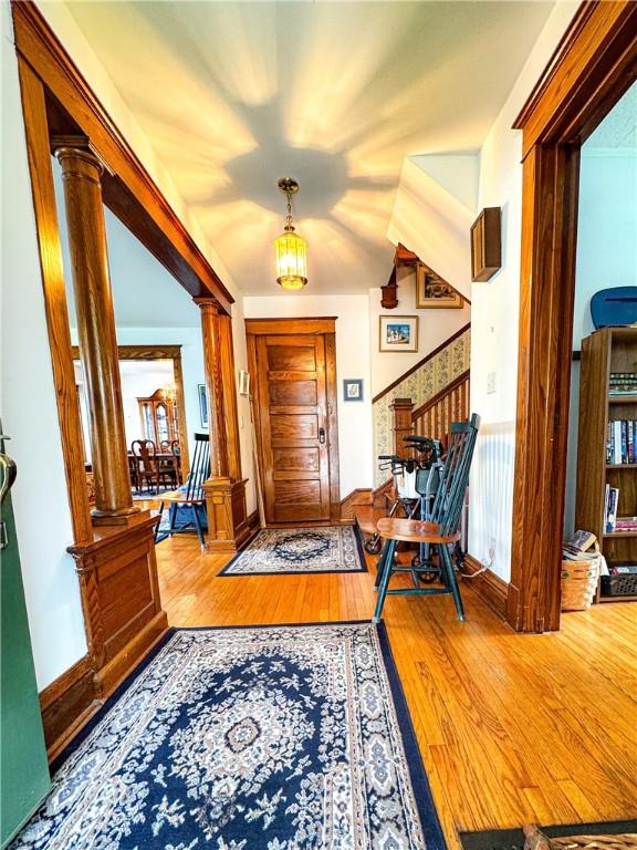80 E Main St, Leroy, NY 14482 - foyer entrance featuring decorative columns, wood finished floors, and stairs