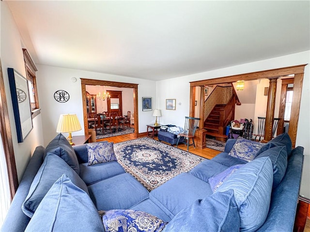 80 E Main St, Leroy, NY 14482 - living room with stairs, wood finished floors, and a chandelier