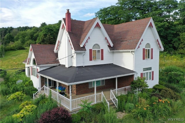 7320 E Flats Rd, East Otto, NY 14729 - view of front of property with a chimney, covered porch, and brick siding