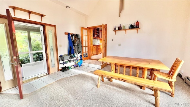 7320 E Flats Rd, East Otto, NY 14729 - tiled dining space with carpet floors and vaulted ceiling