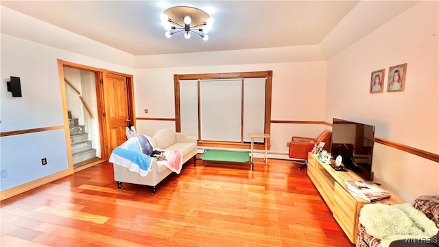 7320 E Flats Rd, East Otto, NY 14729 - living area featuring light wood finished floors, stairway, and a chandelier